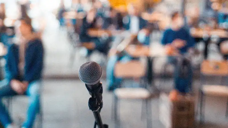 Speaker microphone in front of an audience.