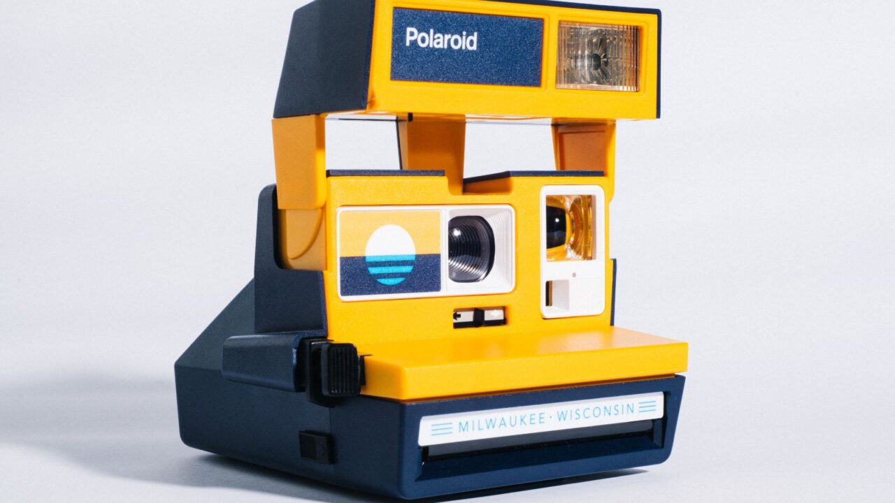 light colored polaroid camera.