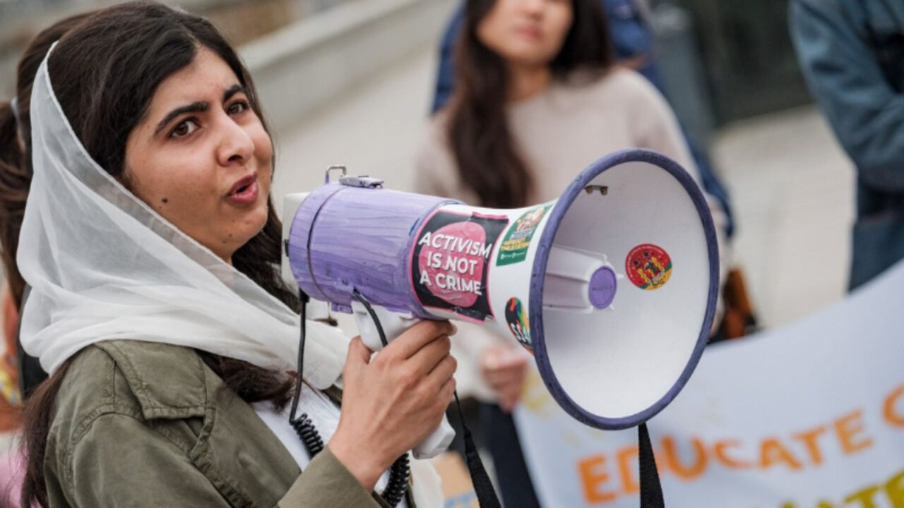 malala yousafzai speaking into megaphone.