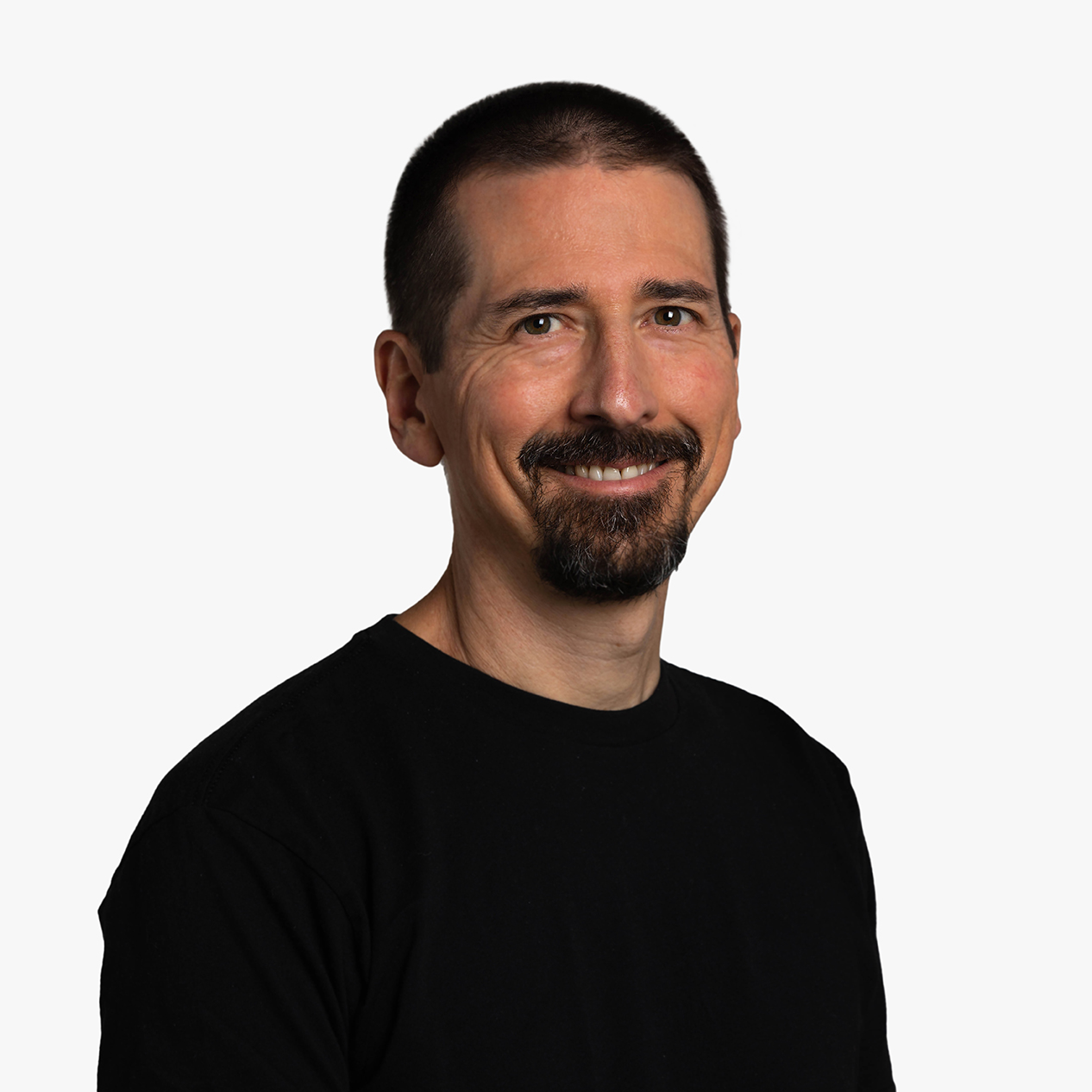 Bill Barbot, a white male in his mid-fifties, wearing a black t-shirt, close-cropped dark hair, and a goatee, photographed from the mid-chest up.