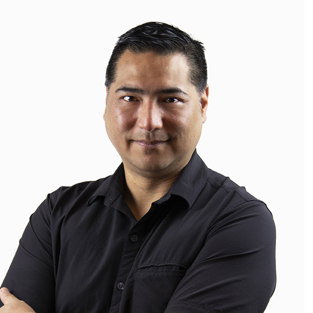 Sid Barcelona, a Filipino-American man with short black hair, wearing a black short-sleeved shirt, smiling and looking into the camera.