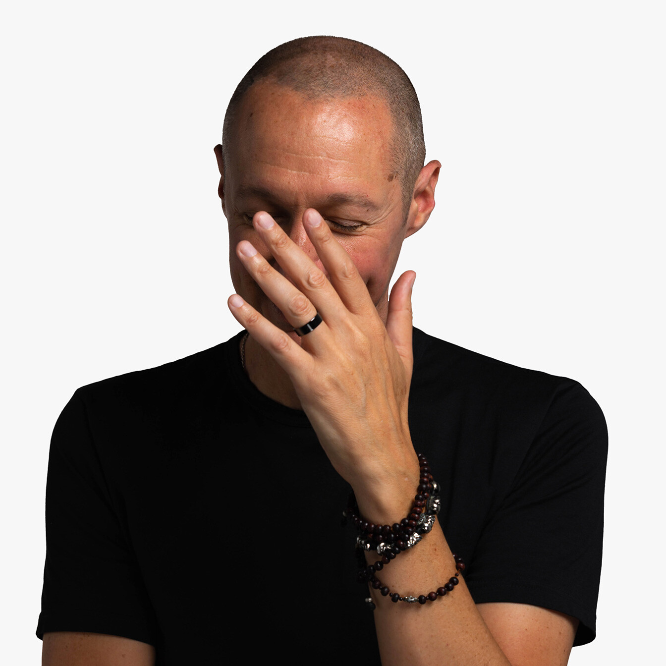 William Colgrove, a rather thin white man with a buzz cut, garbed completely in black, obscuring his smiling face by waving his hands as if to say "I'm embarrassed by all this" or possibly he simply hates having his picture taken.