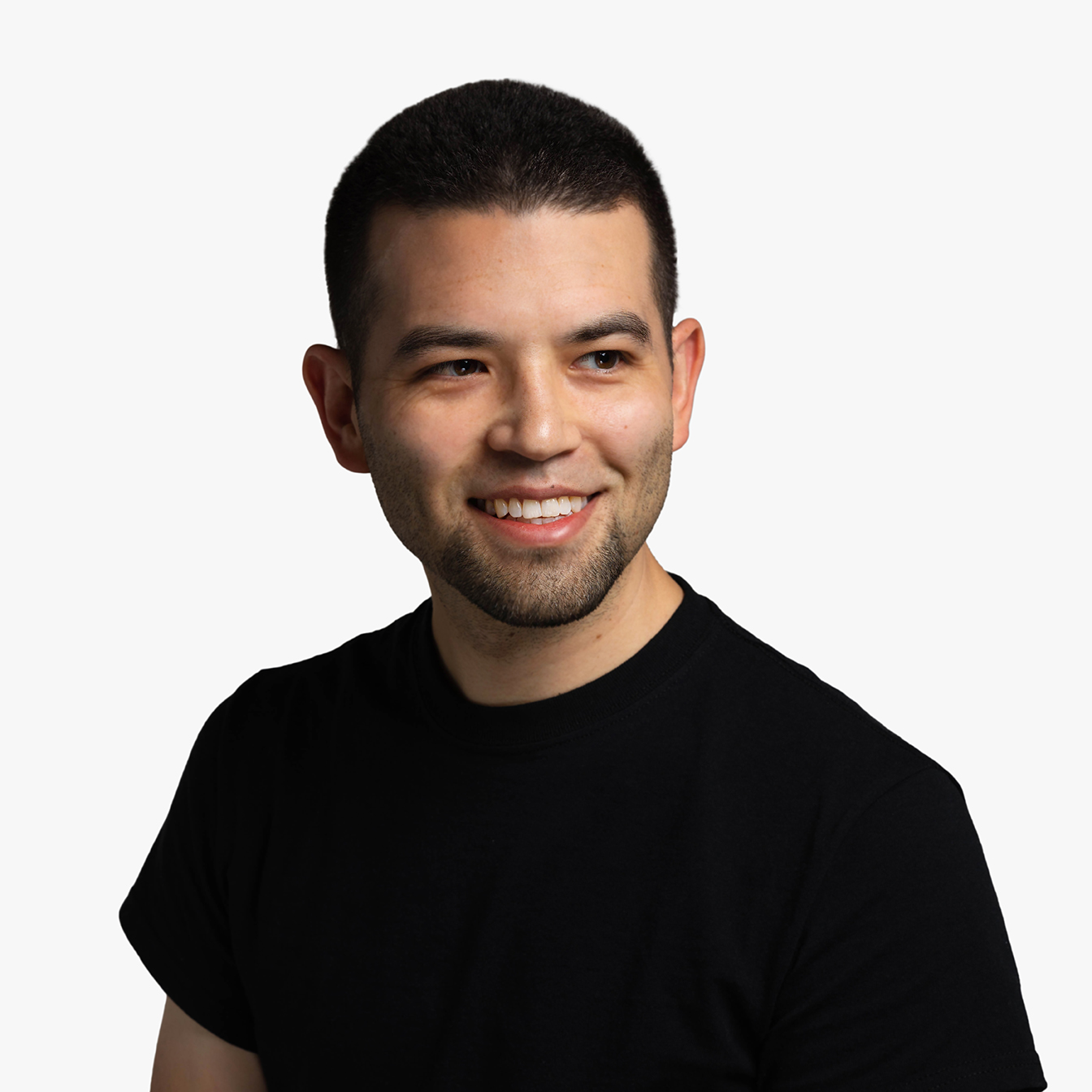 Ted Whitehead, an asian-american man with short black hair wearing a black short-sleeved shirt, smiling and looking into the camera.